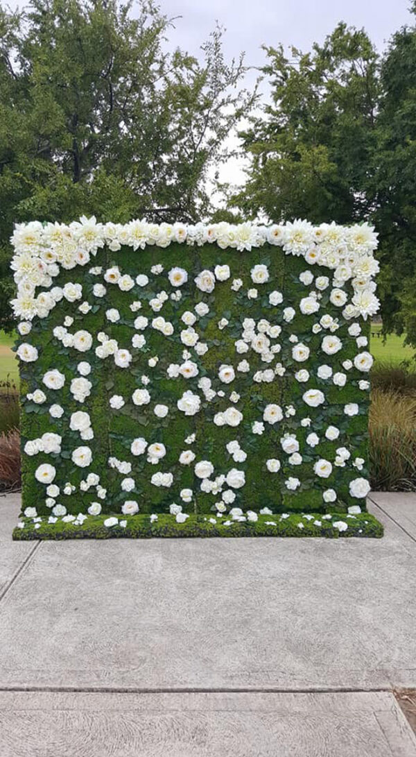 White florals and greenery flower wall