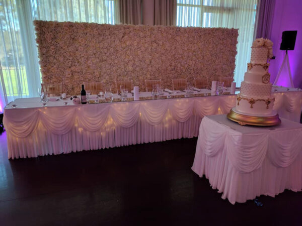 'Double' white flower wall behind bridal table